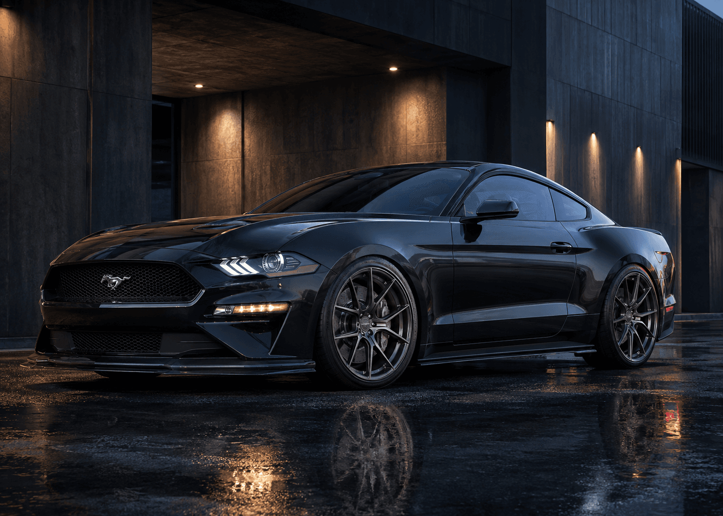 Black sport coupe with forged wheels outside a modern workshop