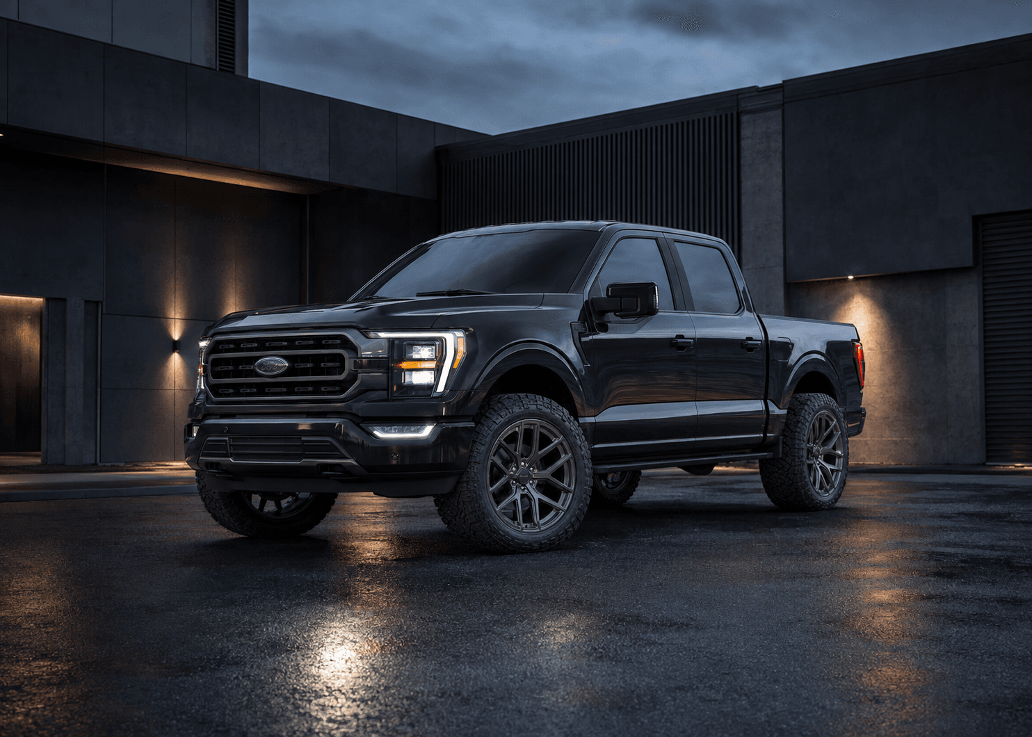 Black pickup with forged wheels outside a modern workshop